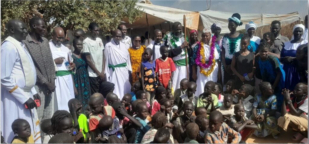 The Bishop with the Clergy take a photo with the Dadaab refugee community